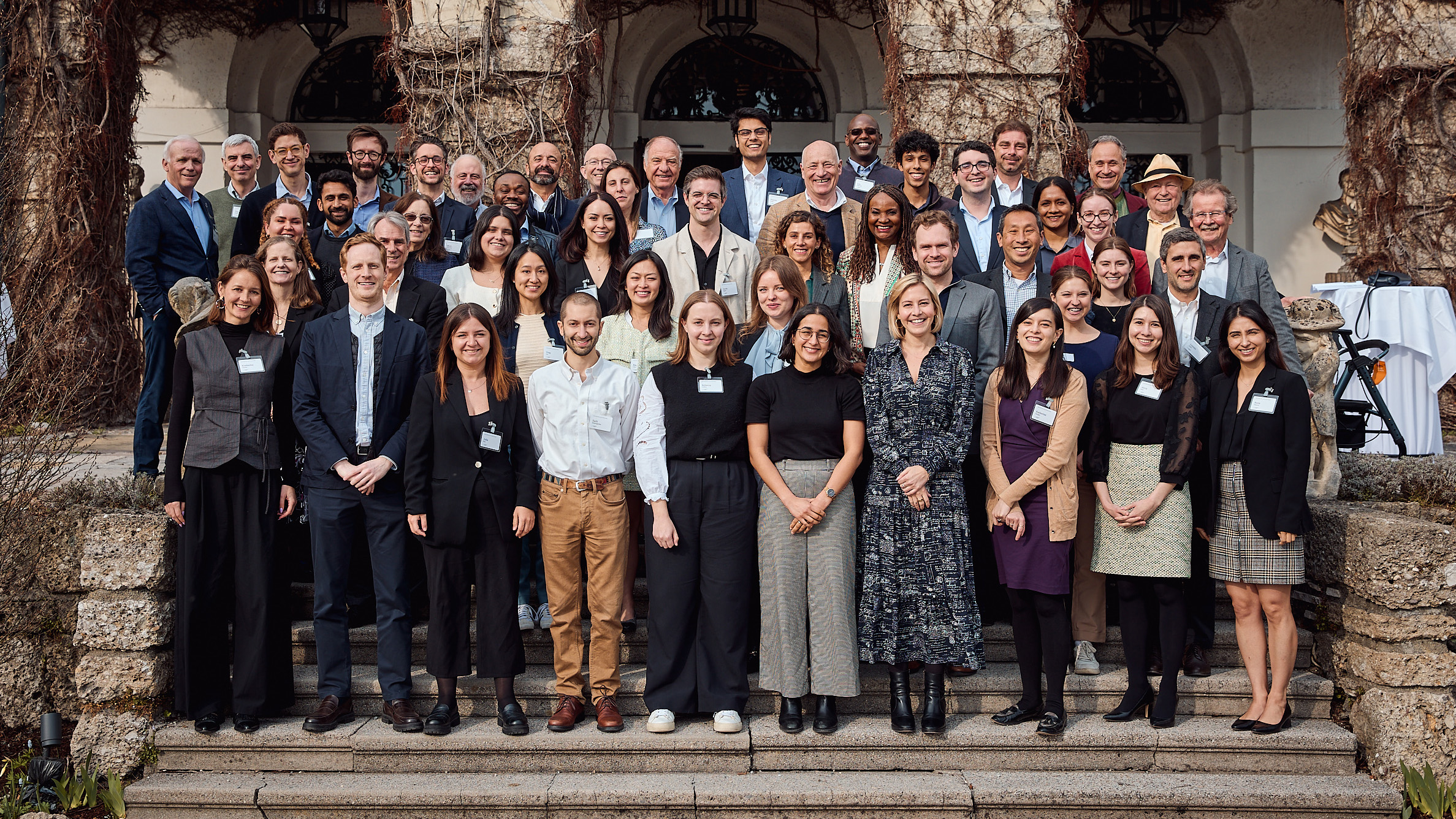 A group of young international law professionals standing in front of Schloss Leopoldskron.