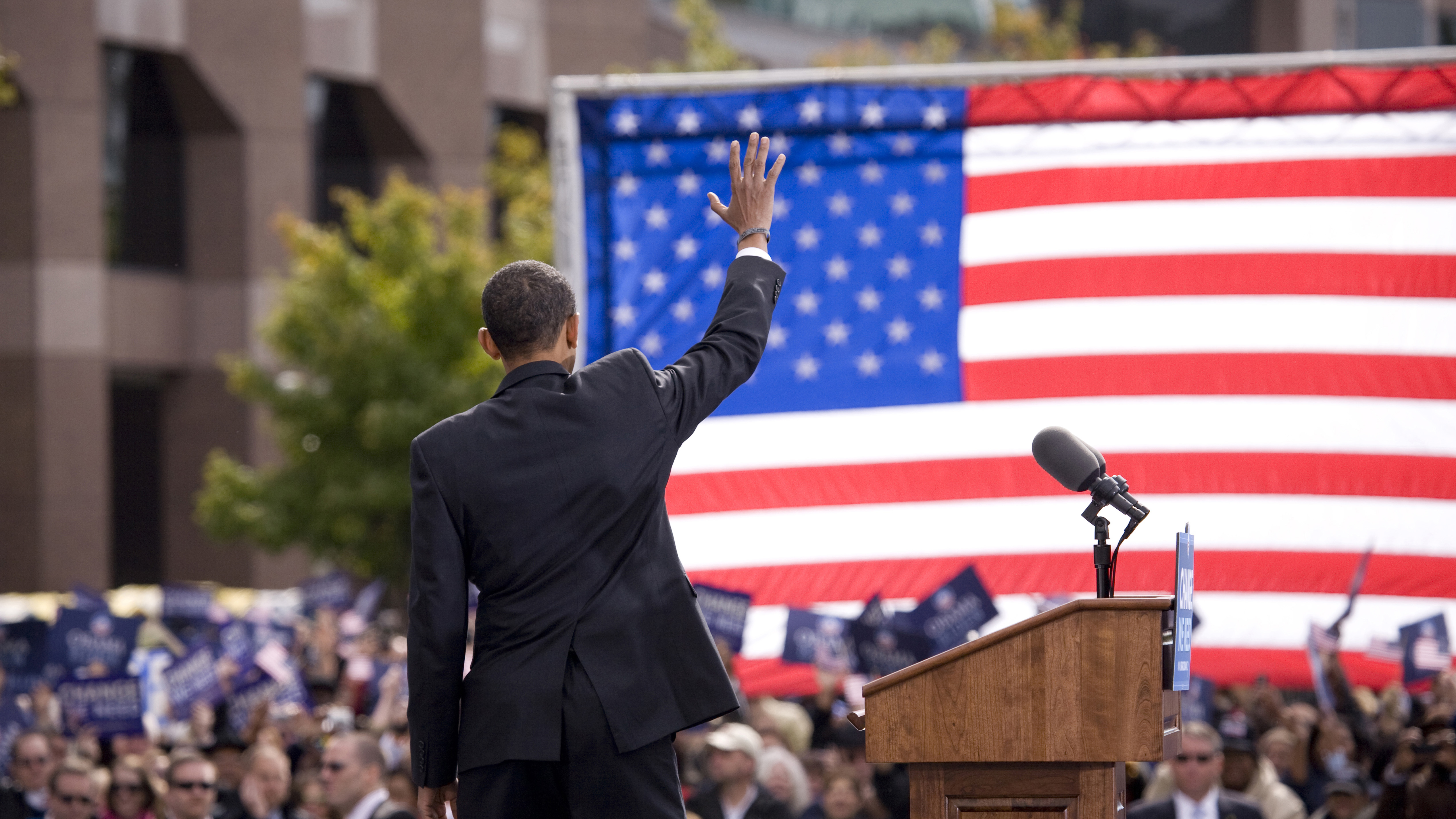 Presidential Candidate Barack Obama waves to crowd as he is framed against American Flag at early vote for change Presidential rally October 29, 2008 at Halifax Mall, Government Complex in Raleigh, NC
